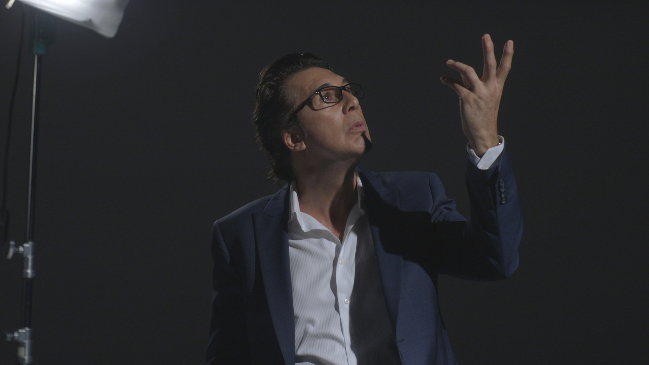Acting out the ‘Face/Off’ gesture in Cage’s iconic scene.
