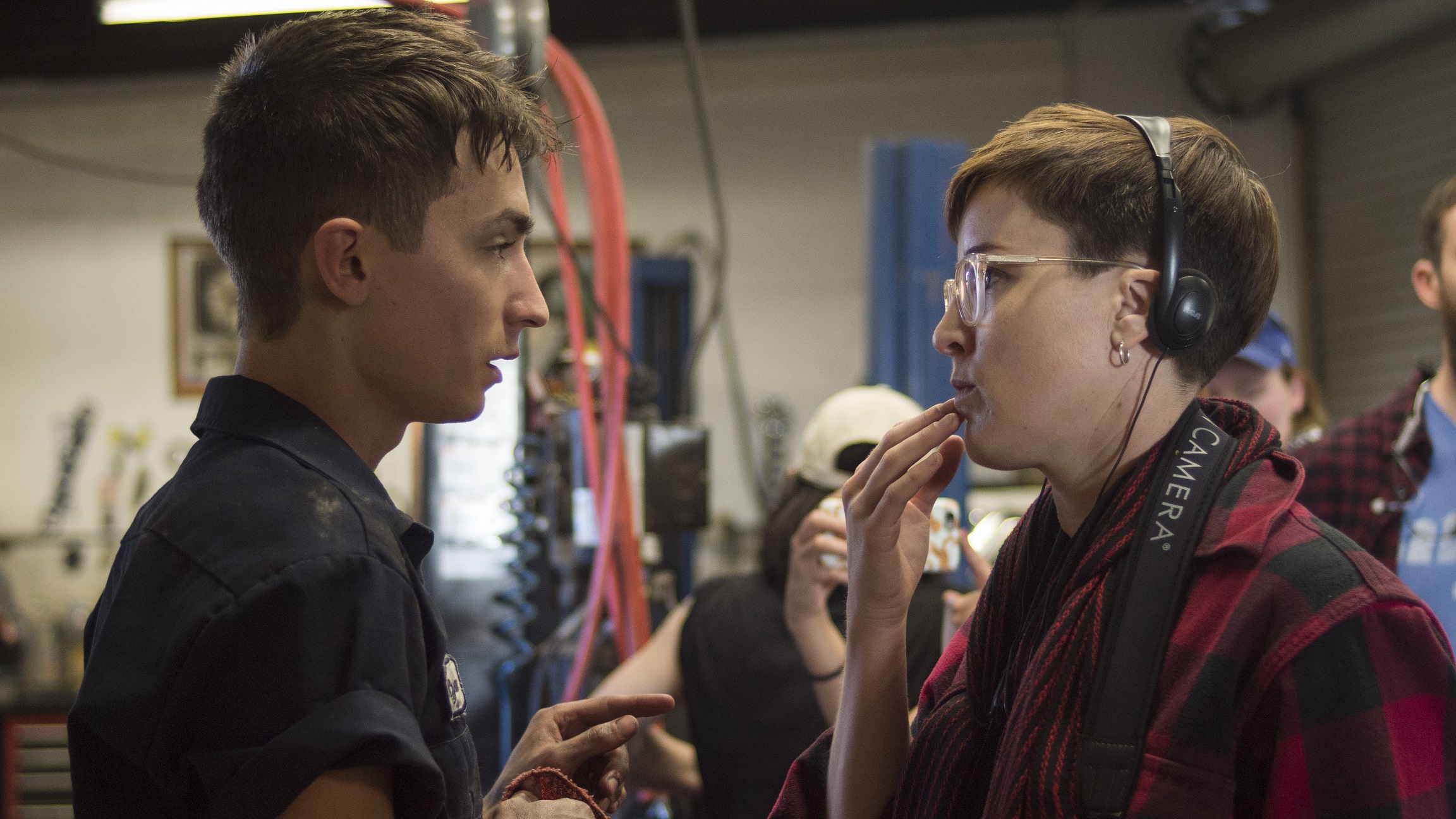 Behind the scenes of iller and Son - Director Asher Jelinsky and lead talent Jesse James Keitel discuss the next scene.