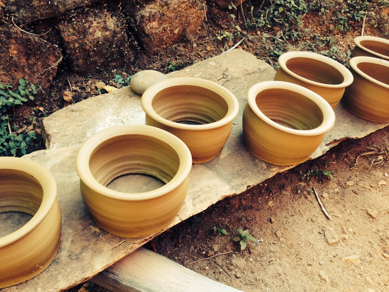  A row of bottomless pots. The bottoms are closed later by hammering the clay sides. 