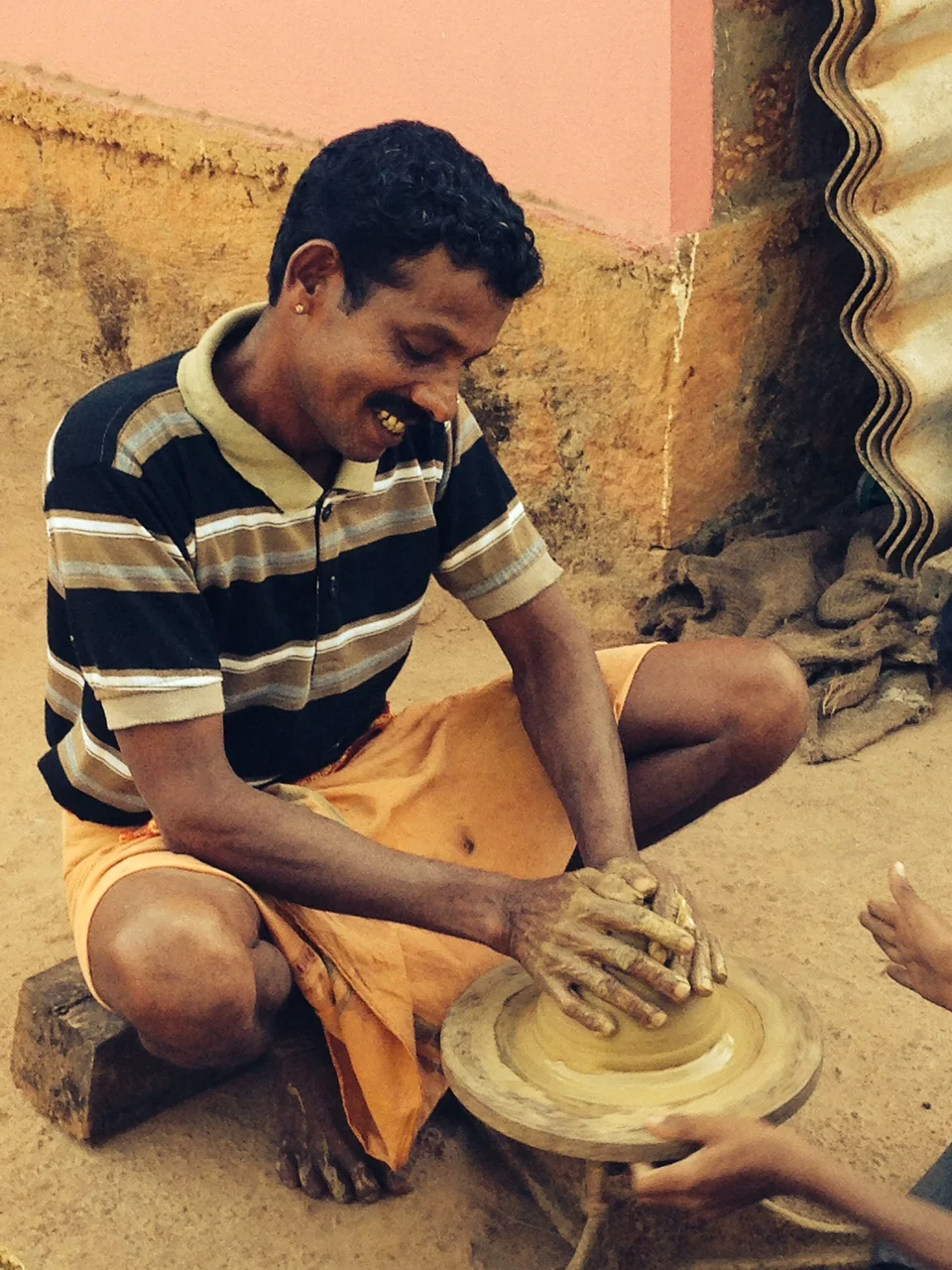  A third-generation rural Indian potter, showing me how he practiced his craft, but shy about being photographed 