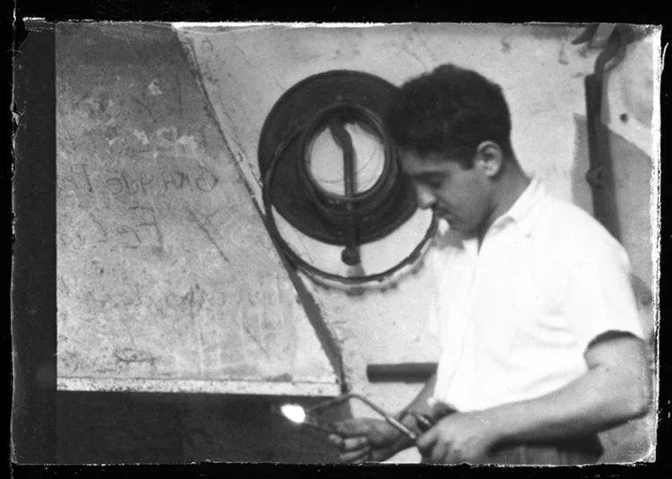 Enio, likely to be at his father’s workshop.