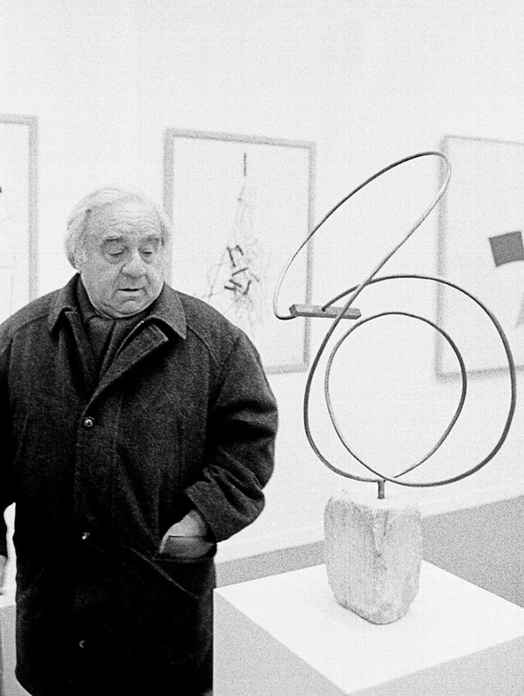 Enio contemplates one of his works purchased by the Grenoable Museum of Art, France, ca. 1996. Photo credit: Leonardo Antoniadis. 
