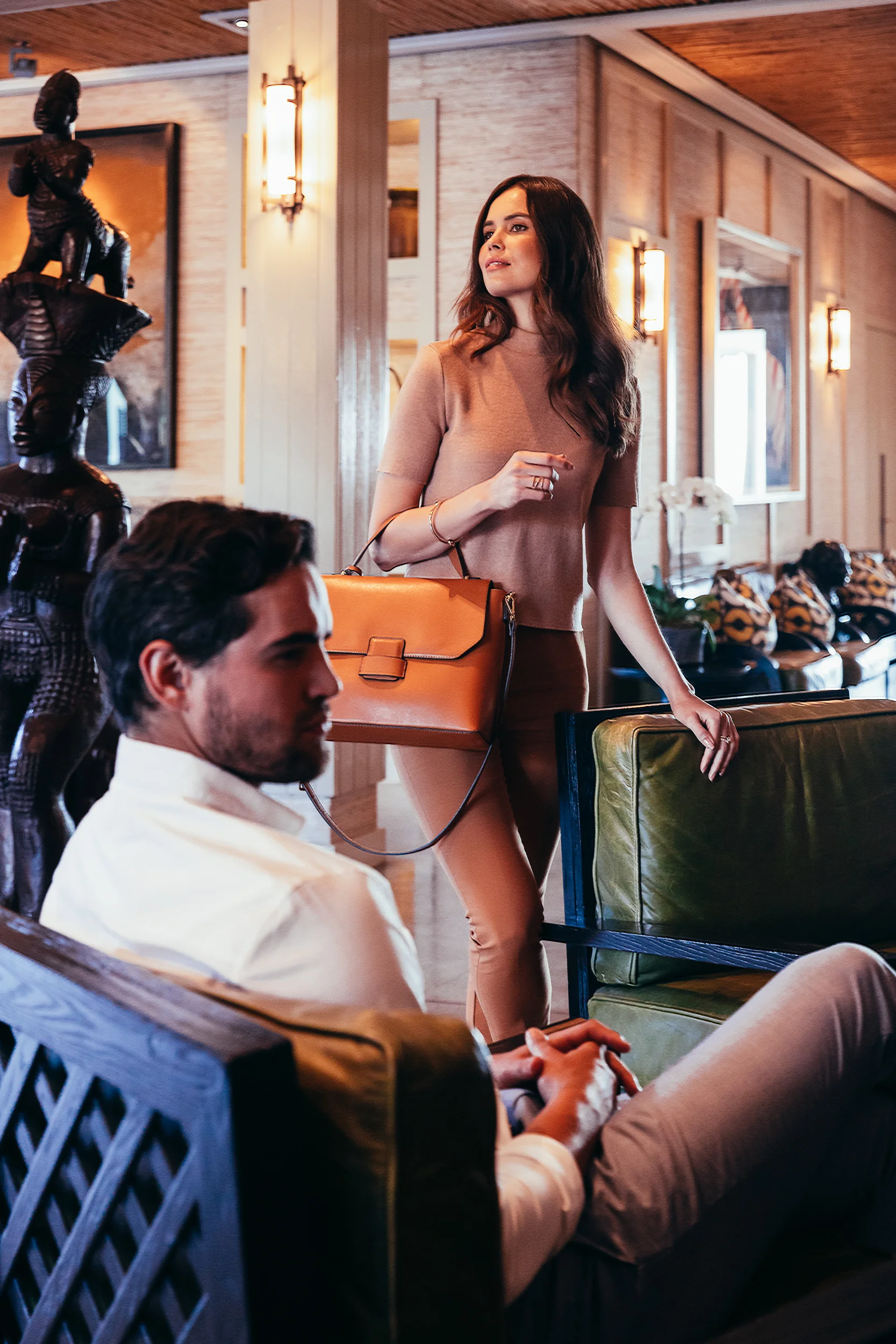 An elegant couple checking in at reception at Delaire Graff Lodges & Spa