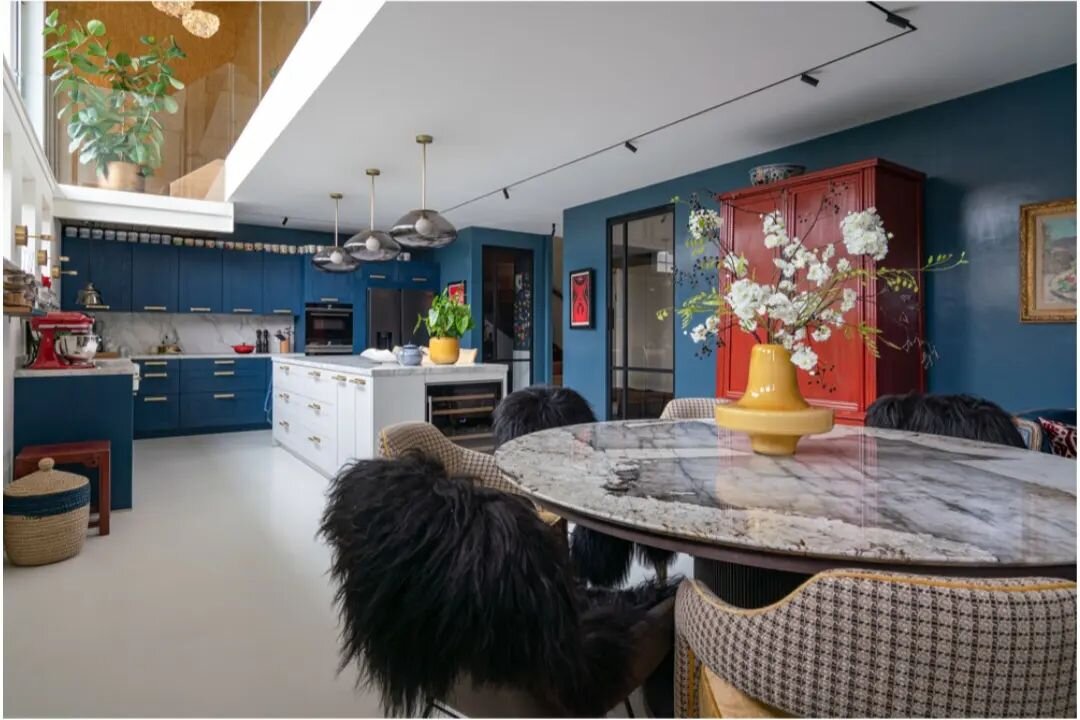 Farrow &amp; Ball 'Stiffkey Blue' in high gloss adds dimension and reflects light in the sub-canal kitchen and dining room of our Amsterdam Canal House Project.  An exquisite hand selected Patagonia marble dining table surrounded by custom chairs cov