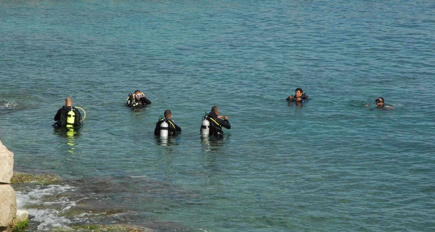 Divers prepare to descend to the remains of the Roman harbor at Caesarea Maritima, Israel.