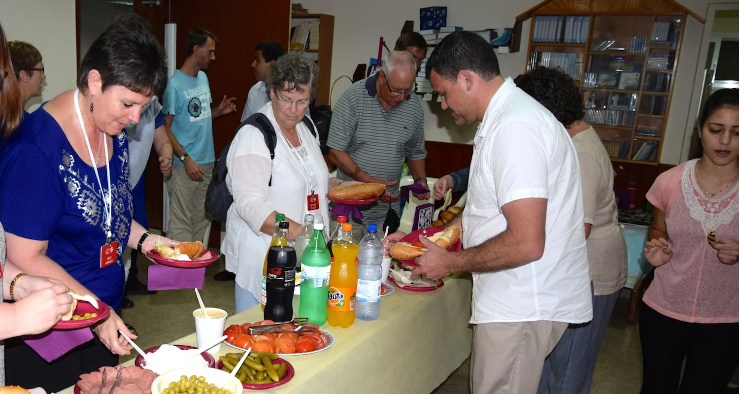 Believers from Galilee and New Zealand share food and fellowship. Photograph courtesy of Mike Taylor member of our 2014 Pilgrimage Tour of Israel-Palestine.