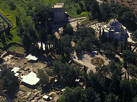 Aerial view to the site. Image taken from the Al Quds University report found here . The “wheel” shaped structure near the center of the picture is the fountain. Ruins, some covered, spread to the lower left. A modern chapel stands in the upper right. 