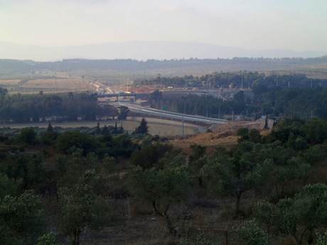 View to the new construction at the Golani Interchange in the Galilee. The McDonald’s is on the far side of the highway; my campsite, in the trees on the right .