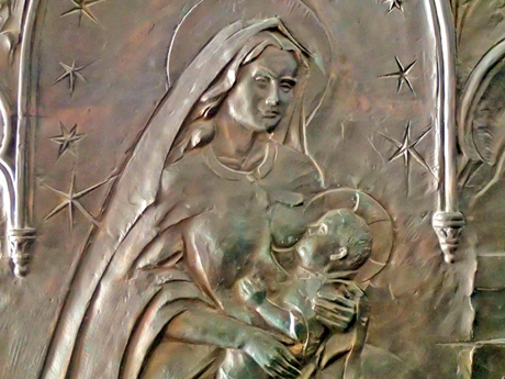 Our Lady of the Milk. Metal image on the front door of the Milk Grotto entrance.