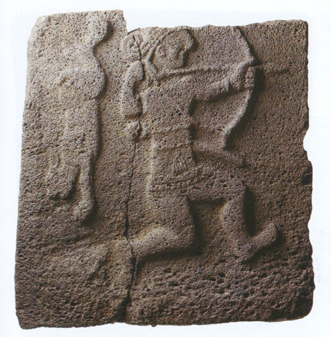 Bow hunter and rabbit on basalt relief found at Samal (Zincirli). On display at the Istanbul Archaeological Museum.