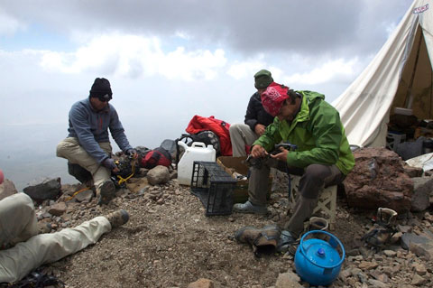 Uraz and the fellas in front of the tent, testing the fit of their crampons.
