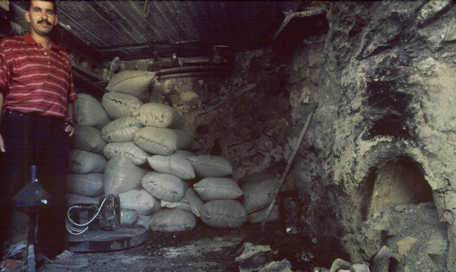 A dung-fired pottery kiln in central Palestine. The firebox is on the right. Sacks of dried dung line the walls.