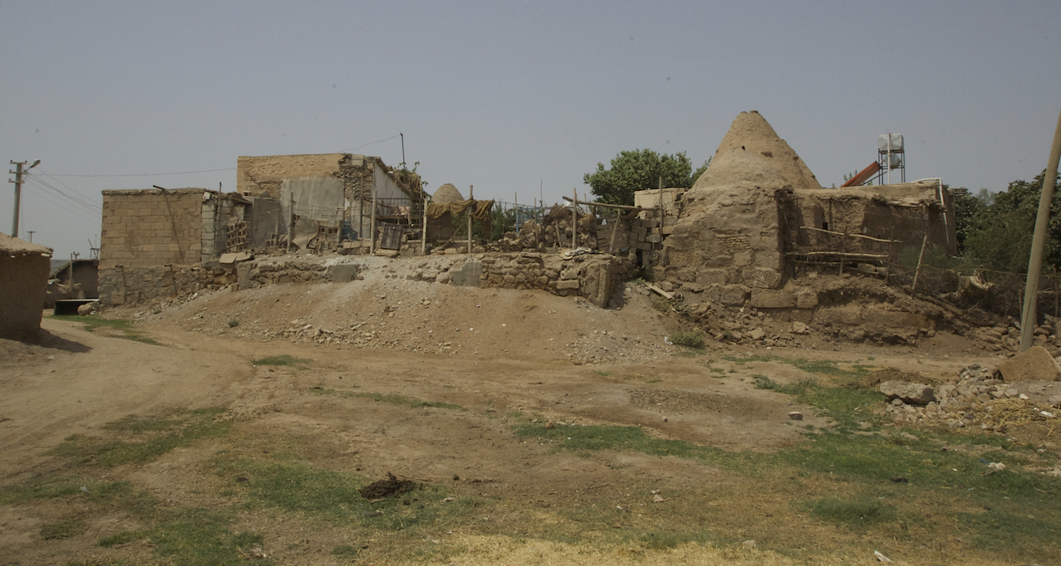 Another domestic compound in modern Haran. Note the water reservoir and red solar panel near the beehive roof.