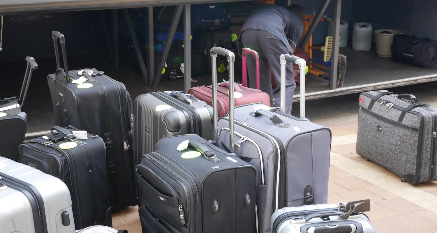 Big bags are loaded in the cargo space under the bus.