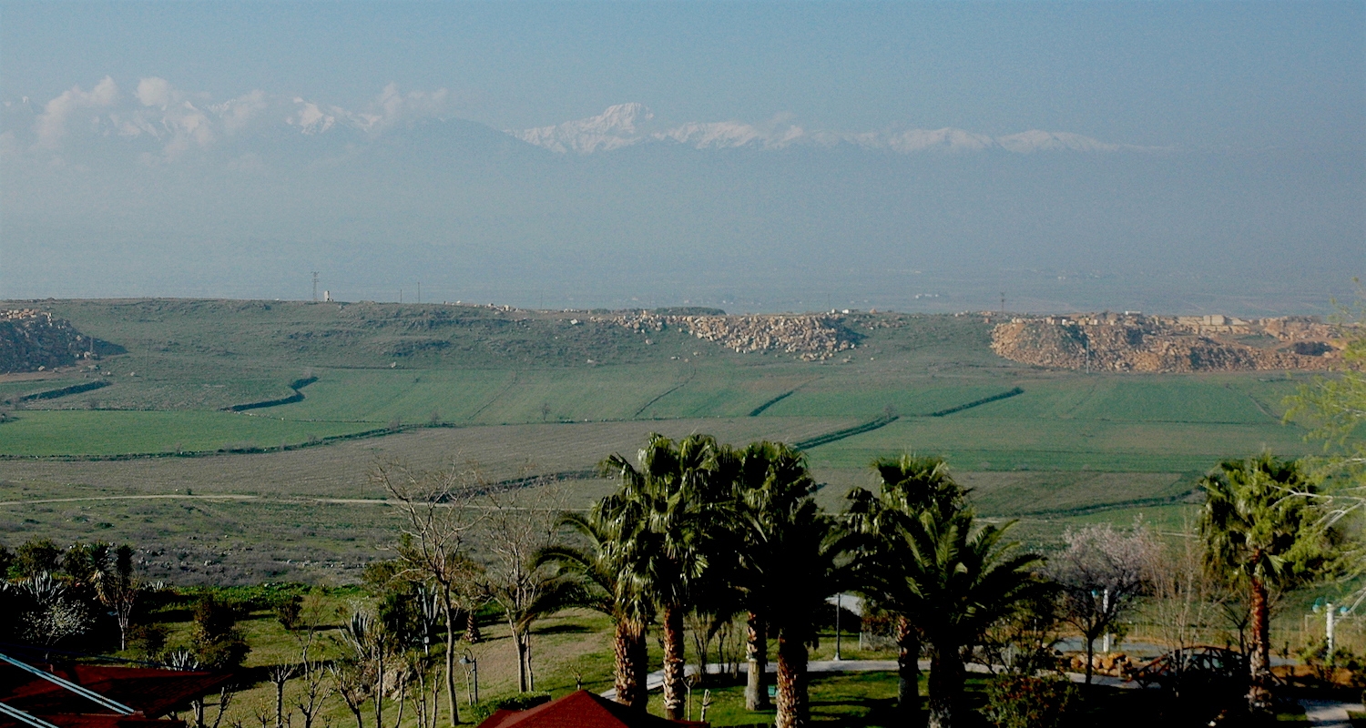 The snowcapped Aegean Blocks (Baba Dagh) rise in the sky. Note the palm trees of Pamukkale (Turkey) near our feet.
