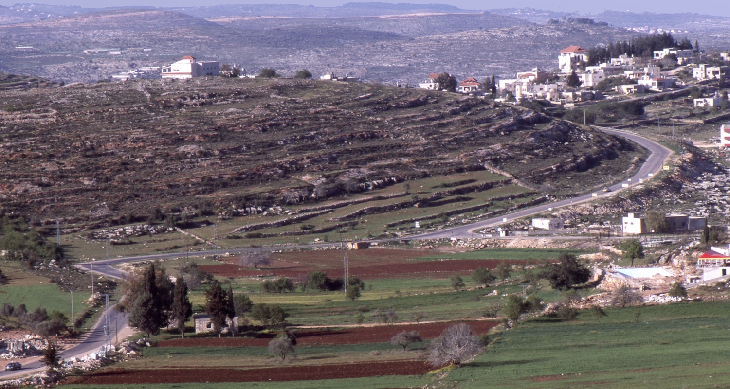 The road between Ramallah and Birzeit (Palestine) winds through naked hills and valleys.