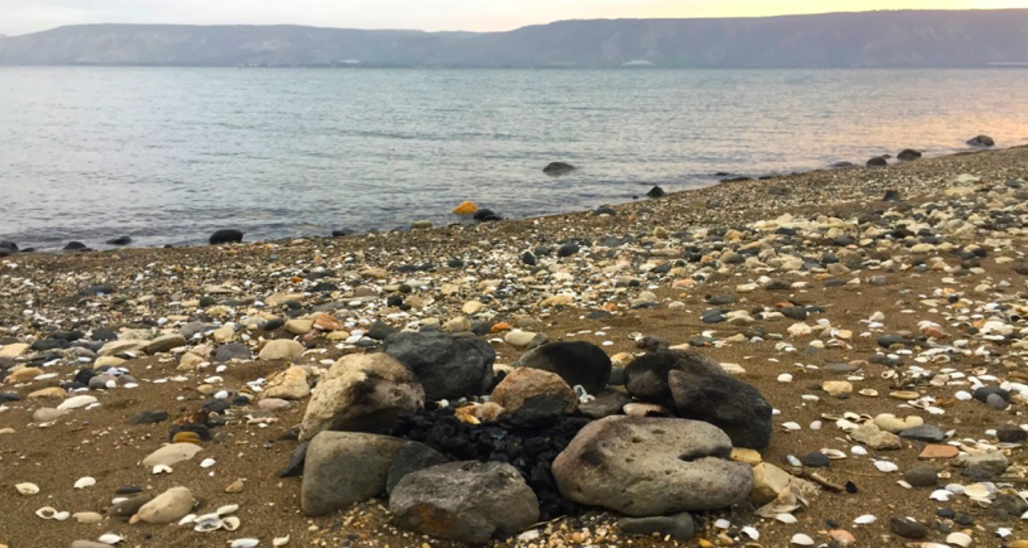 The remains of a fire along the Sea of Galilee.