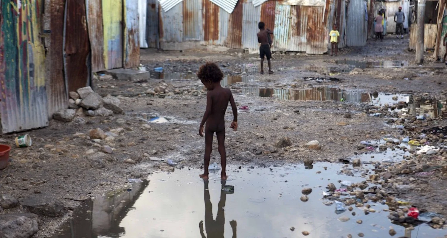 A child plays in a Hatian slum in advance of Hurricane Irma. Image from here.