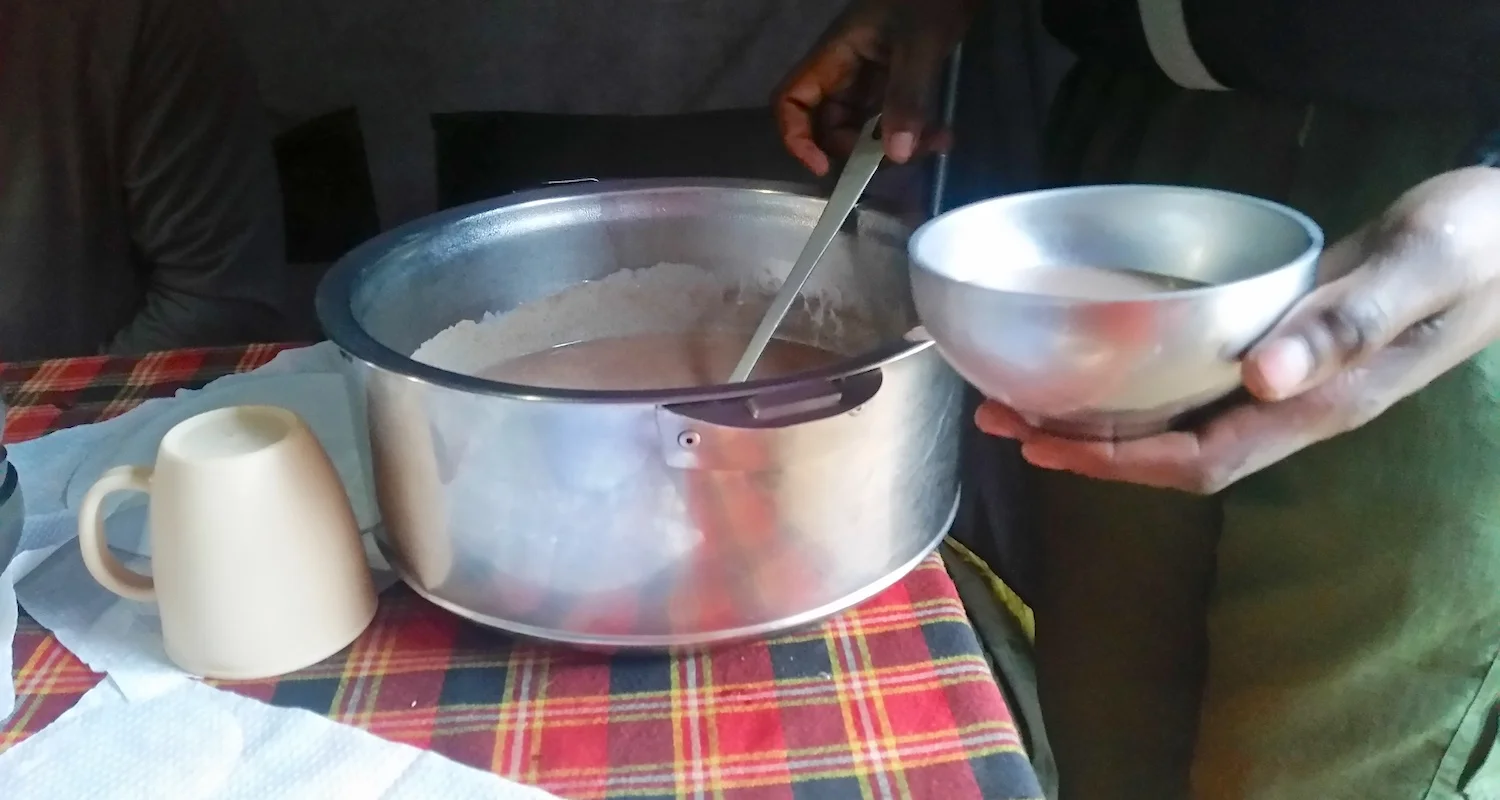 Paul Peter Temba served hot breakfast in the mess tent.