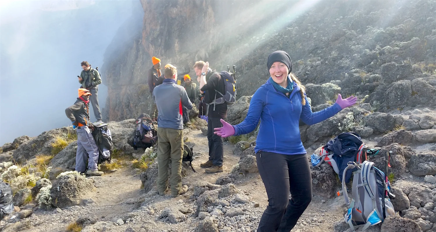 Rachael celebrates on the top of the Wall! Godfrey stands on the left in the light blue pants and orange cap.