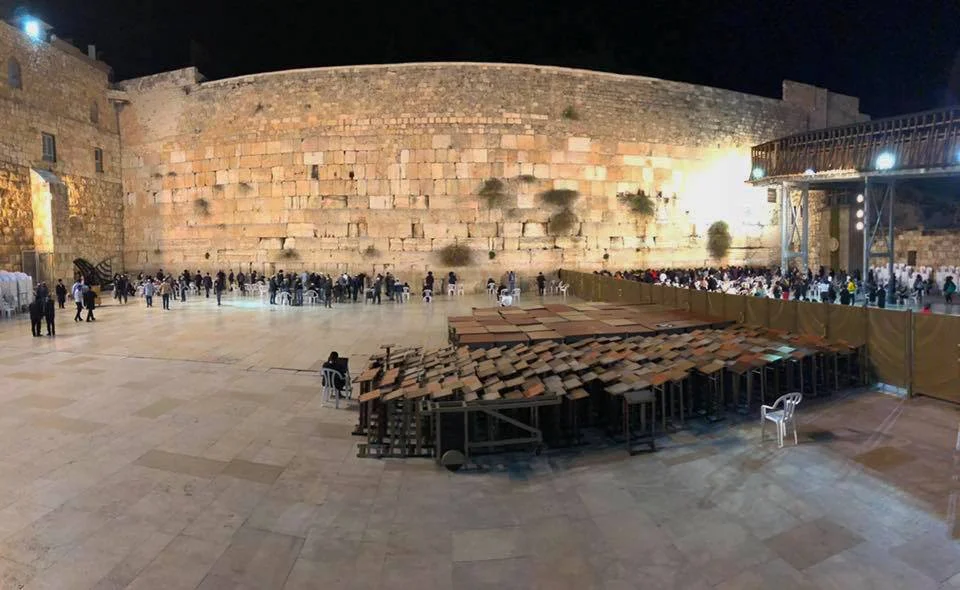 Visiting the Western Wall at night. The wall is not actually part of the ancient YHWH temple in Jerusalem, but rather is one face of an enormous platform built in the Herodian period. The platform supported porches, open courtyards, walls, and, in the center, the Second Temple. The “men’s side” of the Western Wall is pictured here. Image by Tess.