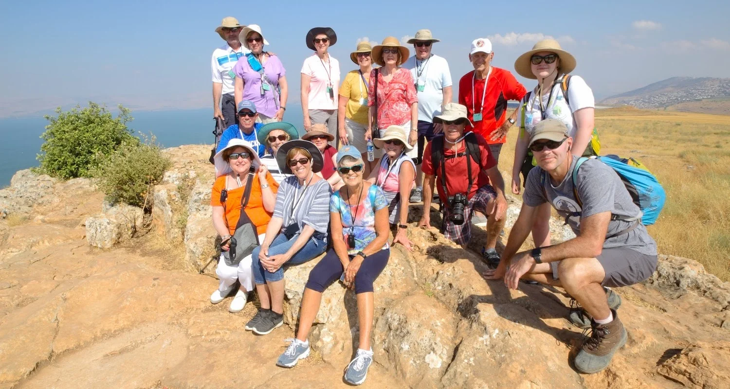 Group photo from the summit of Mt Arbel. The Sea of Galilee shimmers in the distance.