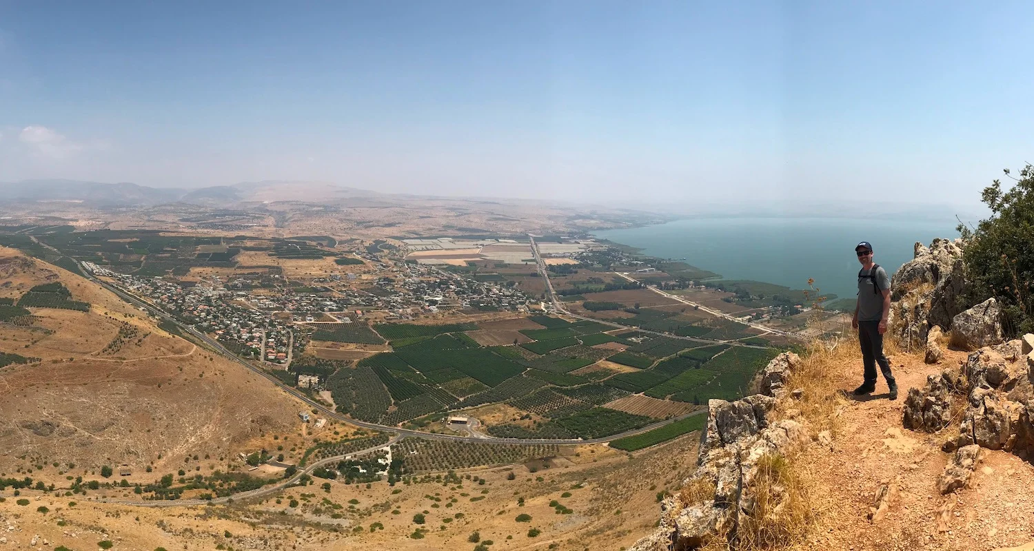 Seth tempts gravity on the edge of Mt Arbel. Below him is the Plain of Genesaret and the Sea of Galilee.
