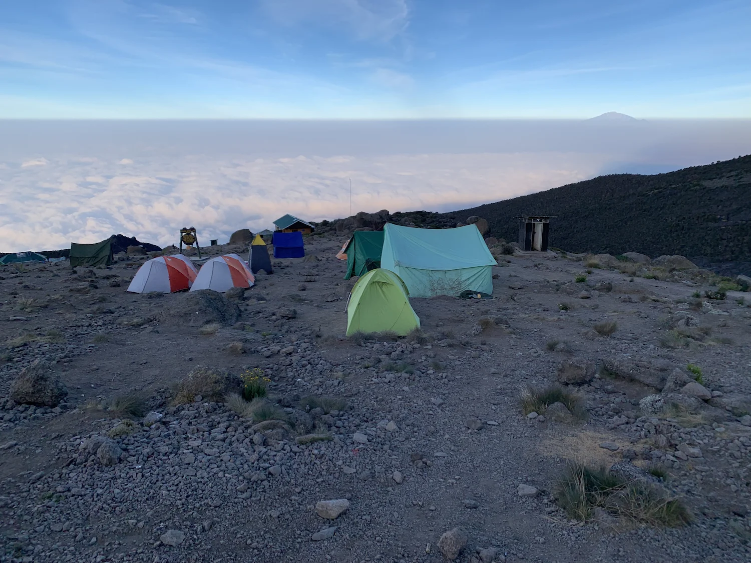 A blanket of clouds swaddled the mountain. Meru is visible on the horizon to the right. Photograph by Bryan, a member of our Kandoo Adventures team.