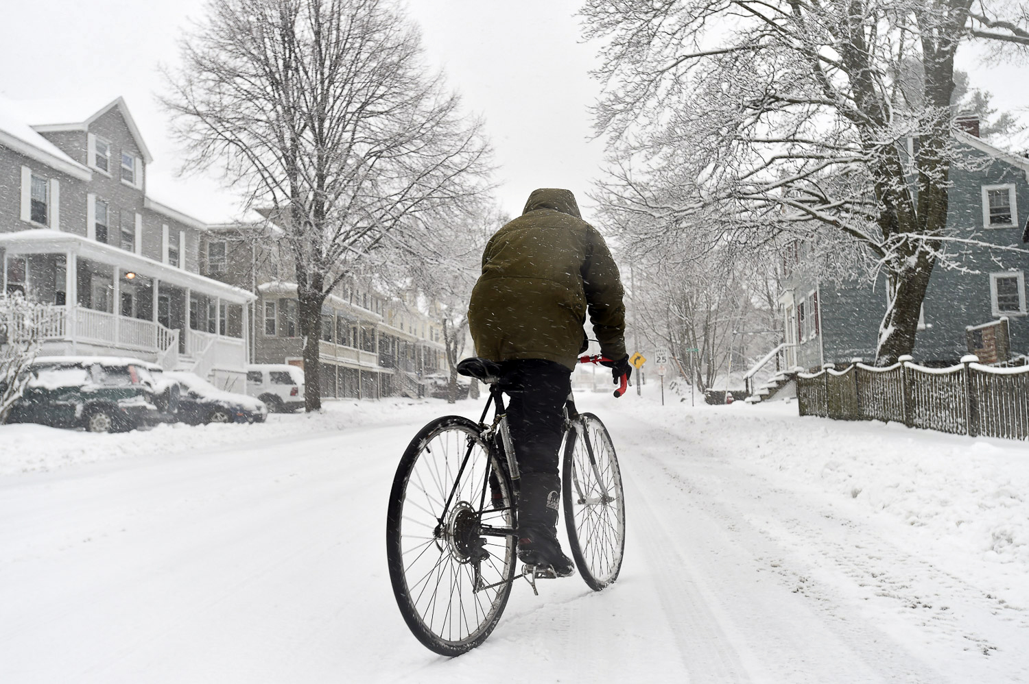 Nikon D4s, 1/250 @ f/5.6, ISO 200, 17-35mm Beverly resident Libby Burns rides a bicycle along Essex Street during Winter Storm Stella.