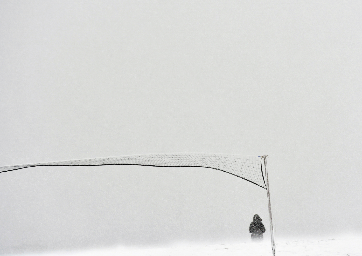 Nikon D500, 1/320 @ f/5.6, ISO 250, 70-200mm A person walks along Devereaux in Marblehead in whiteout conditions during Winter Storm Stella.