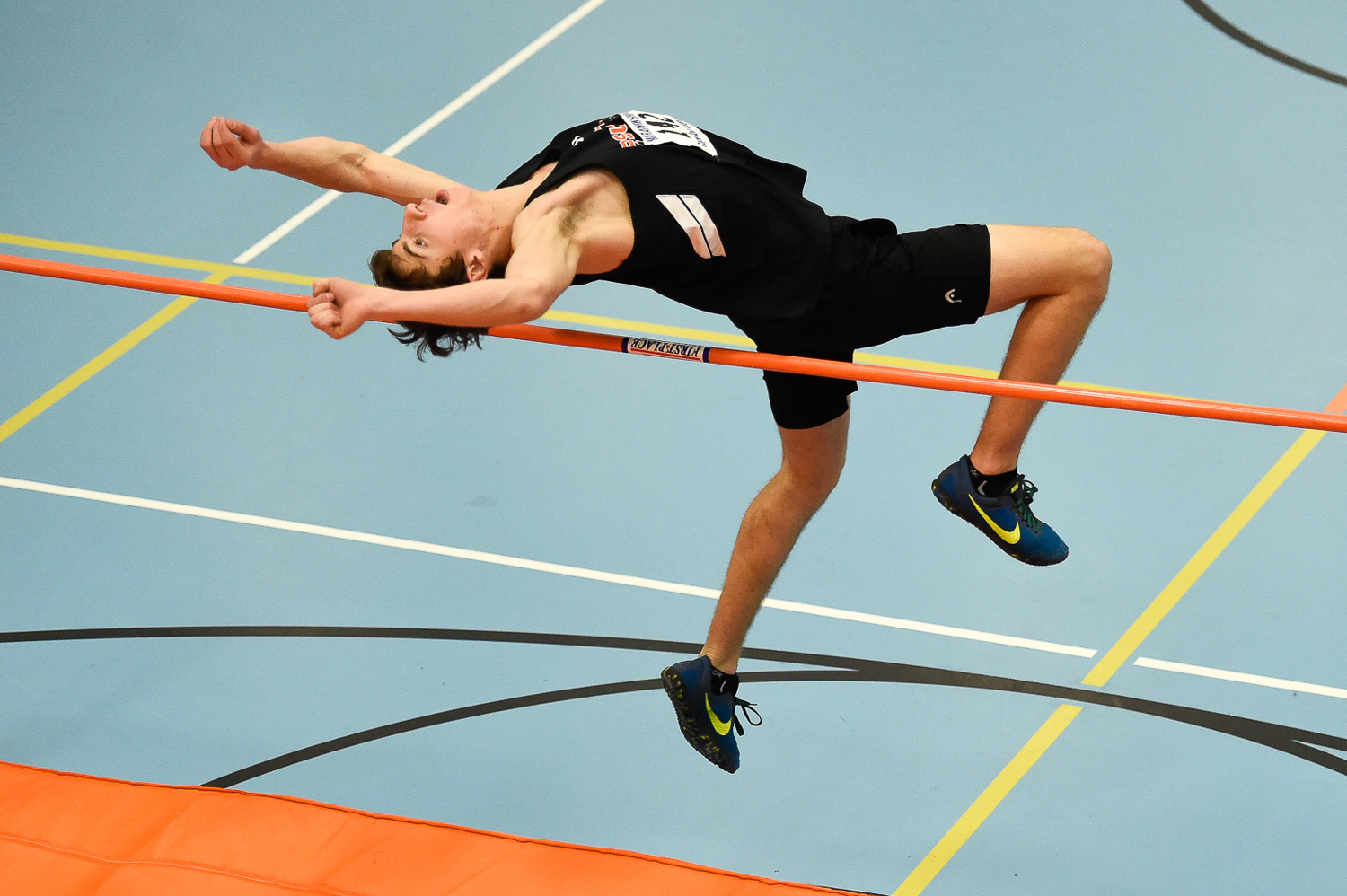 Nikon D4s, 1/1,000 @ f/2.8, ISO 5,000, 70-200mm Nate Rogers of Ipswich competes in the high jump during their indoor track meet at Ipswich High School.
