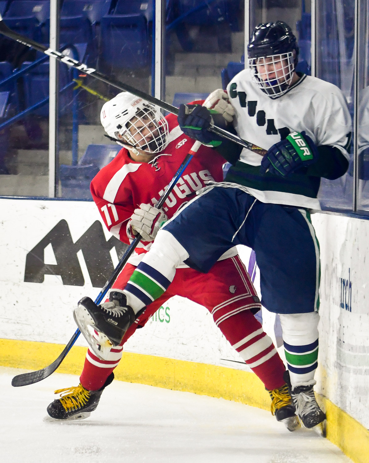 Nikon D4s, 1/1,250 @ f/2.8, ISO 1,250, 70-200mm Ryan Groark of Saugus checks Michael Talbot of Lowell Catholic against the boards during their game at the Tsongas Center at UMass Lowell.