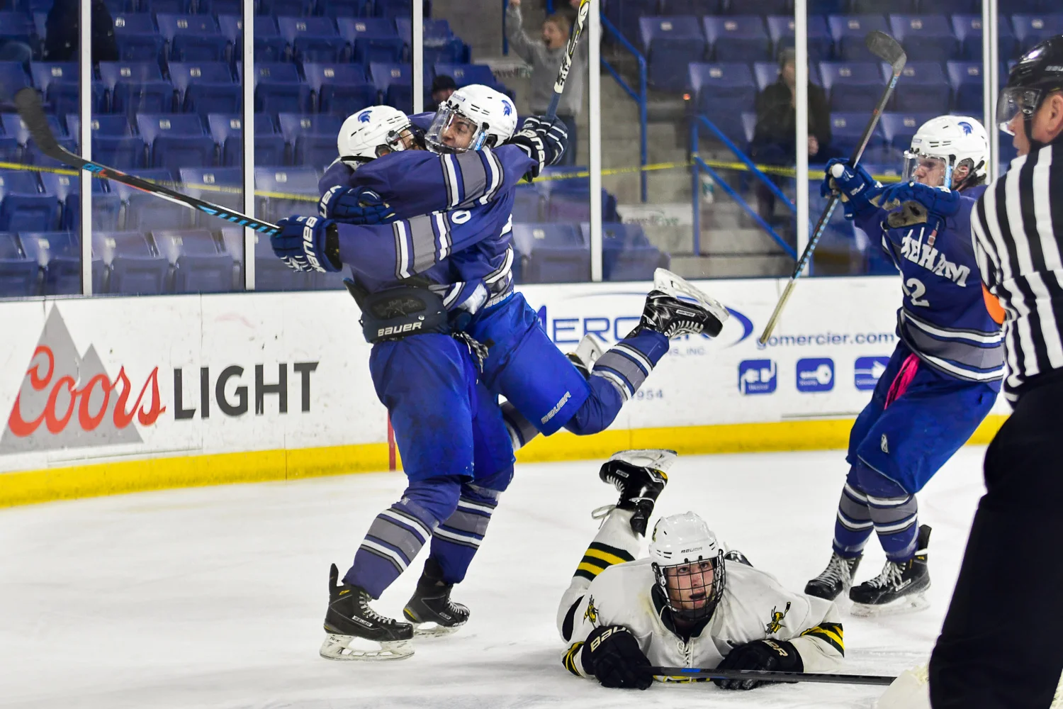 Nikon D4s, 1/800 @ f/2.8, ISO 1,250, 70-200mm Stoneham's Nick Federico, Nick Feliciano, and Adrian Sousa celebrate a goal during their Division 2 North win over North Reading, 2-1, in double overtime at the Tsongas Center at UMass Lowell.