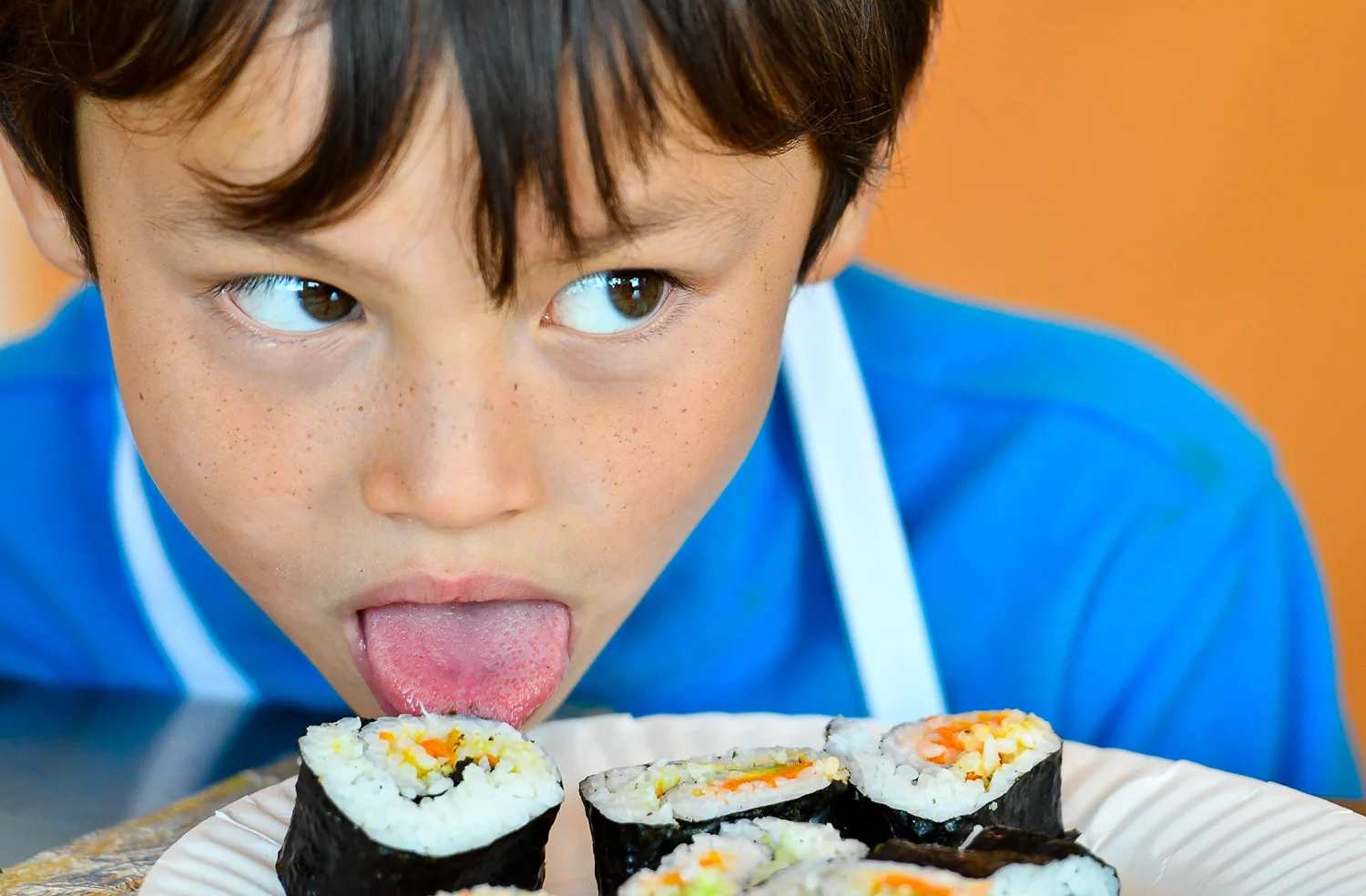 Nikon D500, 1/320 @ f/3.2, ISO 1100, 70-200mm Joey Duffield, 8, uses his tongue to get a taste of sushi he made during a cooking class at Taste Buds Kitchen in Beverly, Wednesday, Oct. 18, 2017.