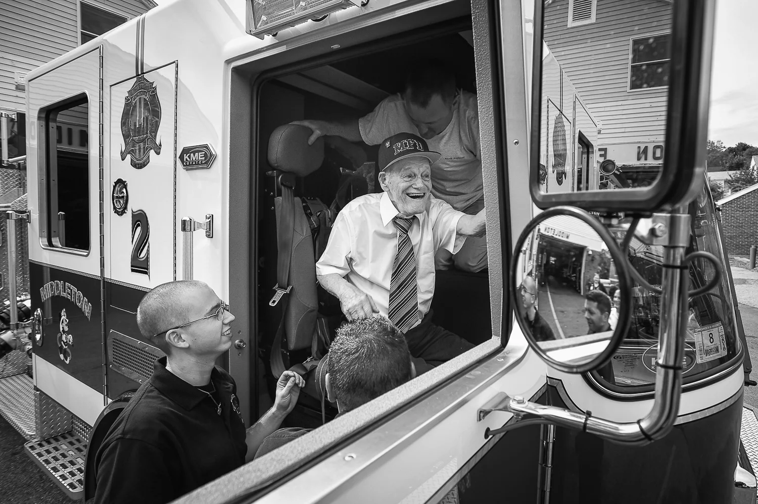 Nikon D4s, 1/250 @ f/5.6, ISO 100, 17-35mm Honorary Middleton firefighter Bobby Jensen, 89, is helped into Middleton Engine 2 as he prepares to go for a ride around the block during his visit at the Middleton Fire Department, Thursday, Sept. 14, 2017.