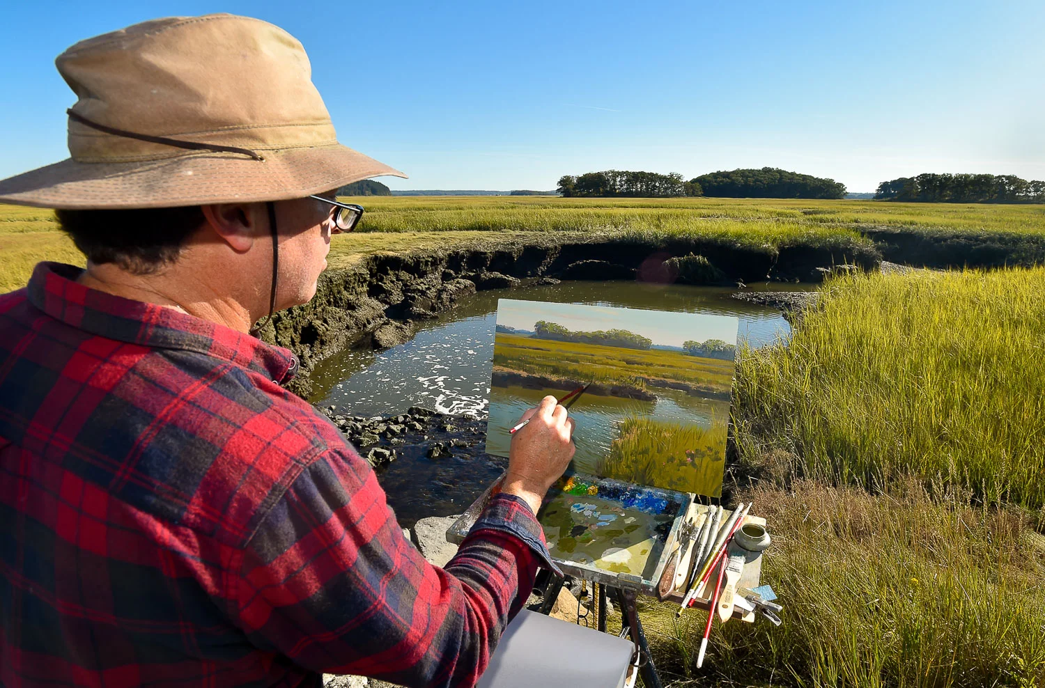 Nikon D4s, 1/400 @ f/8, ISO 200, 17-35mm Professional artist Mark Shasha uses oil paints as he works on a painting looking over a marsh along Argilla Road in Ipswich, Wednesday, Oct. 4, 2017.