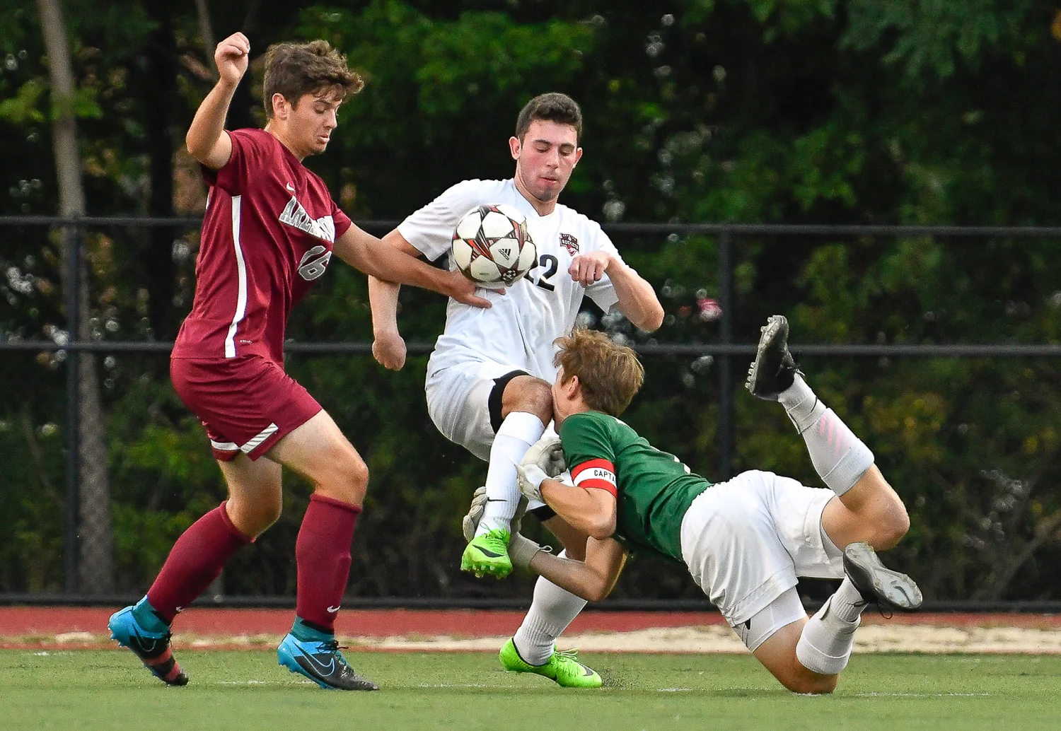 Nikon D500, 1/1250 @ f/4, ISO 2000, 70-200mm with a 1.4x Dustin Rosh, center, of Reading, accidentally knees his goalkeeper Alex Katsoufis in the face while being pressured for the ball by Will Clifford of Arlington during their game at Reading High School, Thursday, Sept. 14, 2017.