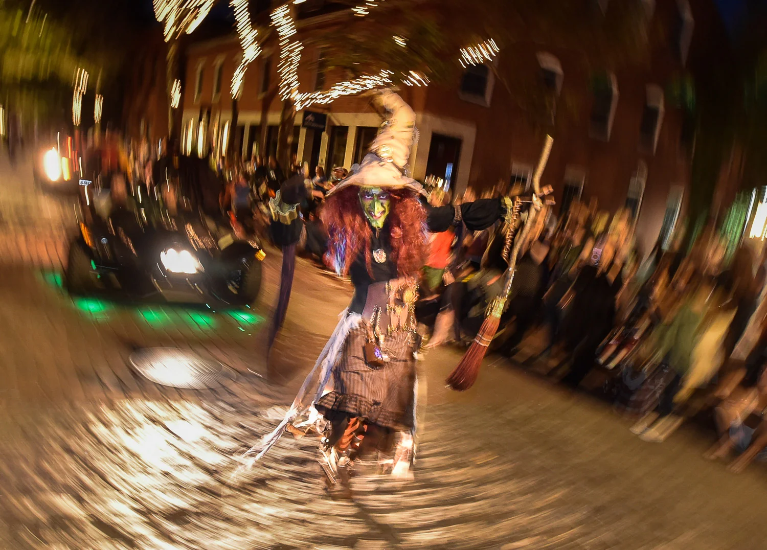 Nikon D4s, 1/13 @ f/4.5, ISO 3200, 17-35mm A person dressed as a witch scares people along Front Street during the Haunted Happenings Grand Parade in downtown Salem, Thursday, Oct. 5, 2017.