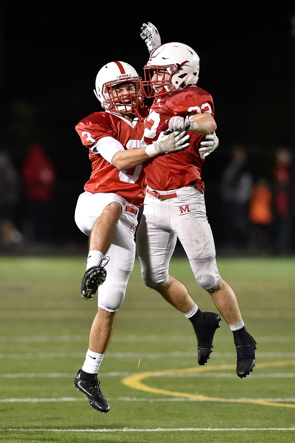 Nikon D4s, 1/1250 @ f/2.8, ISO 8000, 300mm Louis Izzi Jr. and Colin Kiernan of Melrose celebrate at the conclusion of their 14-10 win over Dracut at Melrose High School, Friday, Oct. 27, 2017. 