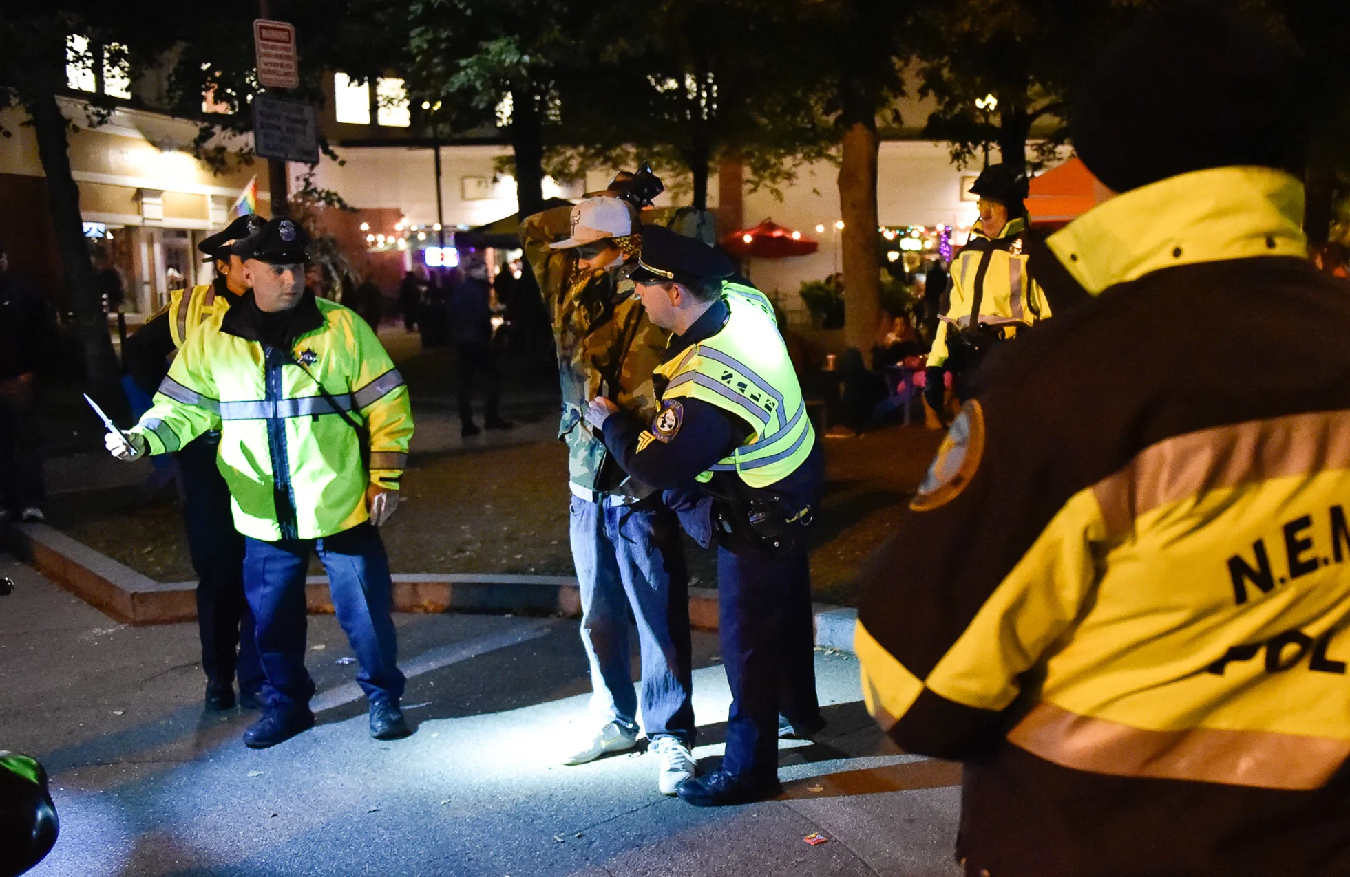 1st Place, Spot News Photo A Salem police officer, left, holds a switchblade knife, which was allegedly found on this man, near Washington and Essex Street on Halloween night in Salem on Monday, Oct. 31, 2016.