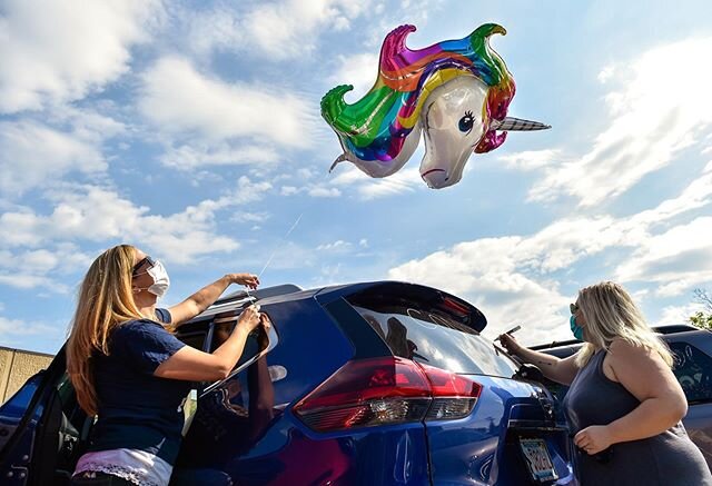 Medford High School Counselor Tori Glasser and Alana Bruno decorate a car in the Medford High School parking lot before the start of the Senior Parade where faculty paraded around the city and greeted high school graduates along the way on Wednesday,