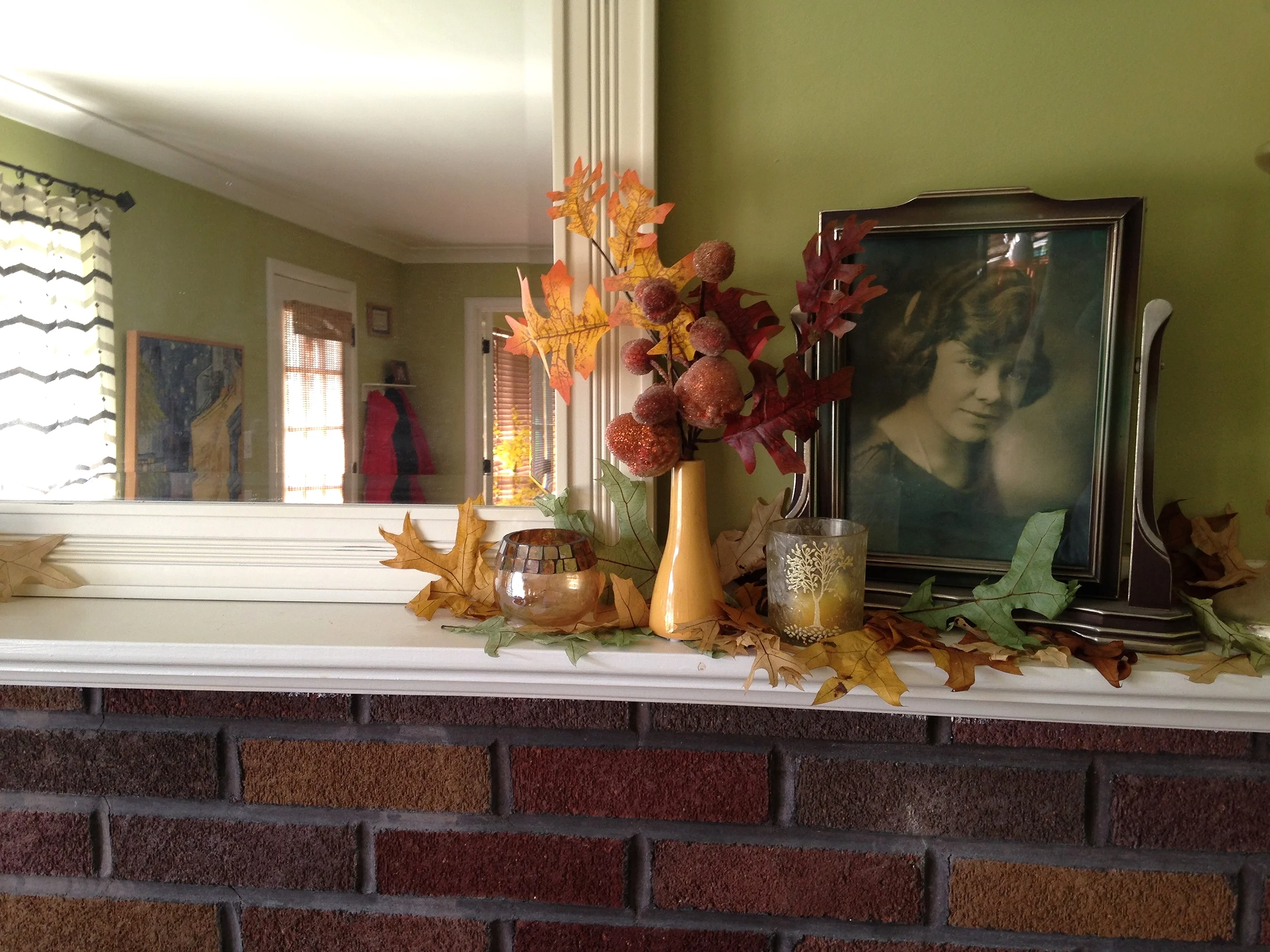 Notice the leaves randomly placed through the decorations...gives that illusion of freshly fallen leaves. &nbsp;Also colorful accents; the yellow bud vase, the decorative votive candle holders....and my dear Grandmother