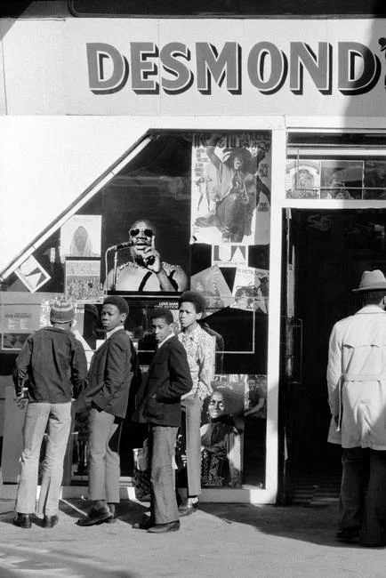 GB. ENGLAND. Brixton. School children outside Desmond's Hip City record shop in Brixton. 1973.