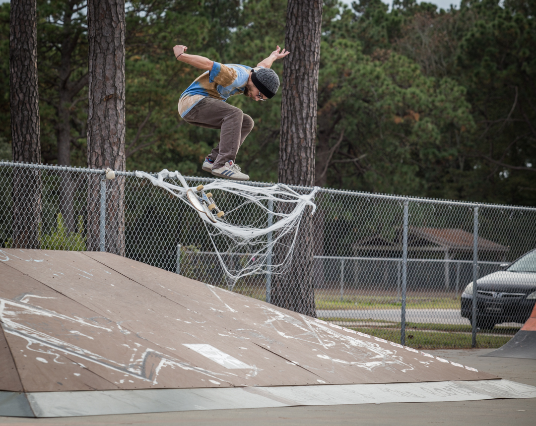 Tie dye shirt guy with a heelflip.