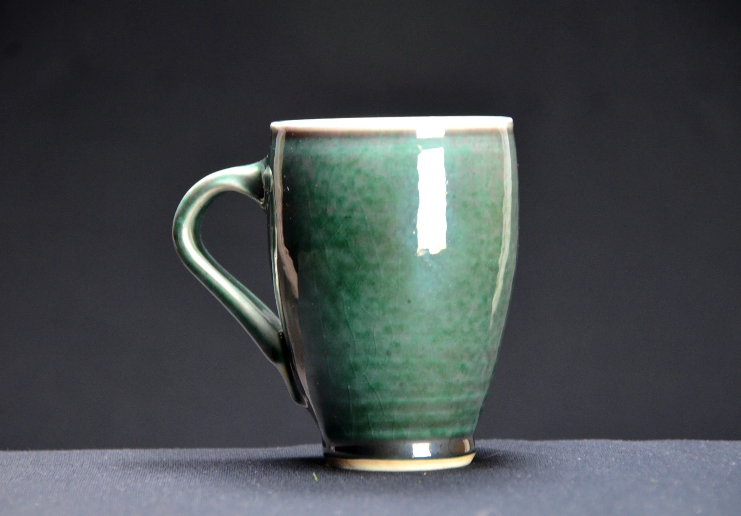 Porcelain Green Coffee Cup | Hand thrown porcelain on a potter's wheel. High Fired, Cone 10, Copper Teal Glaze, Hand Trimmed, Ceramic | Caldwell Pottery