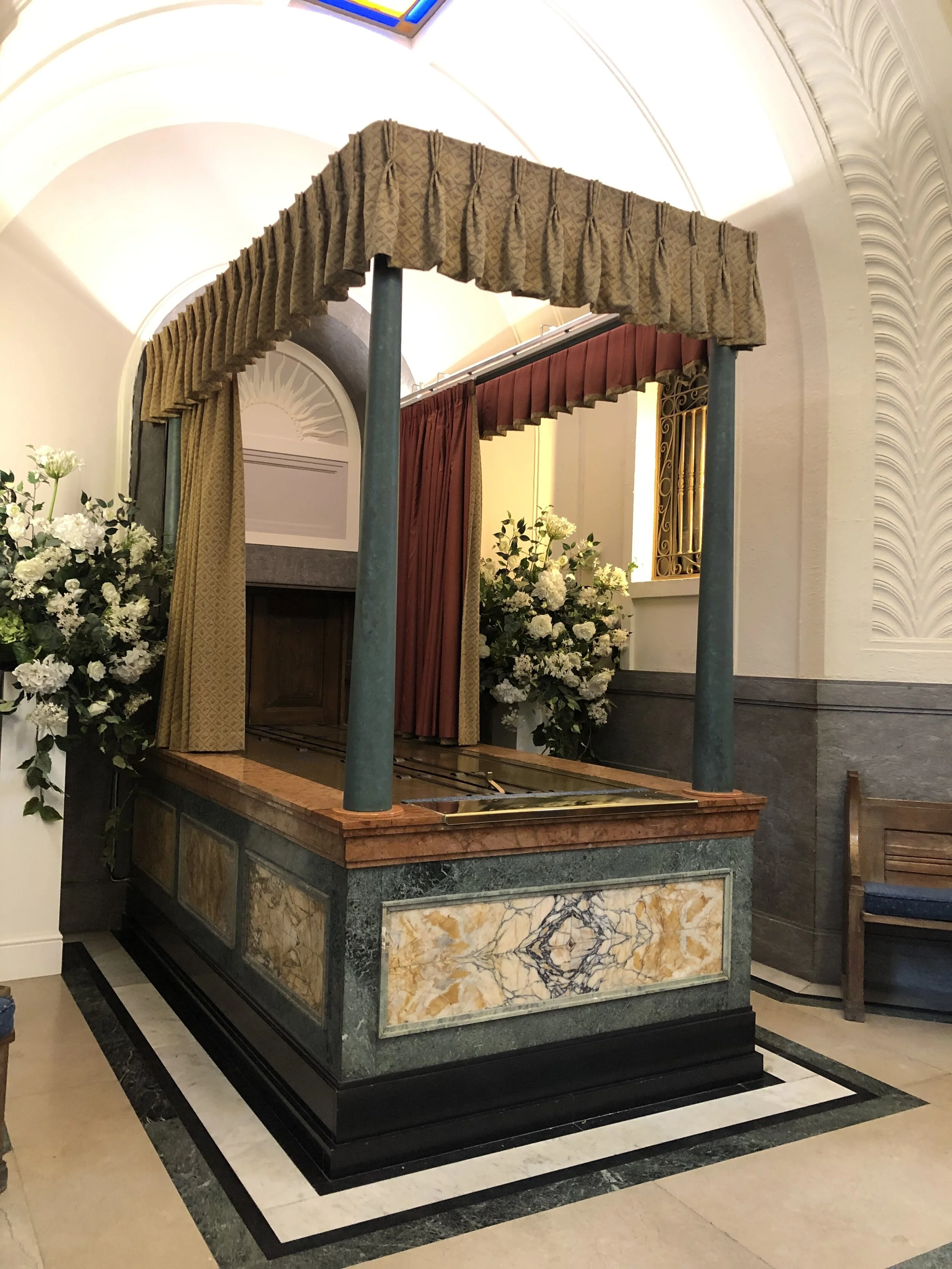 The marble catafalque and curtained canopy at Mortlake Crematorium