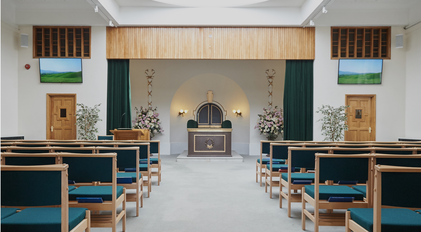 Front of the Islington Crematorium chapel with seating, tribute screens and lectern