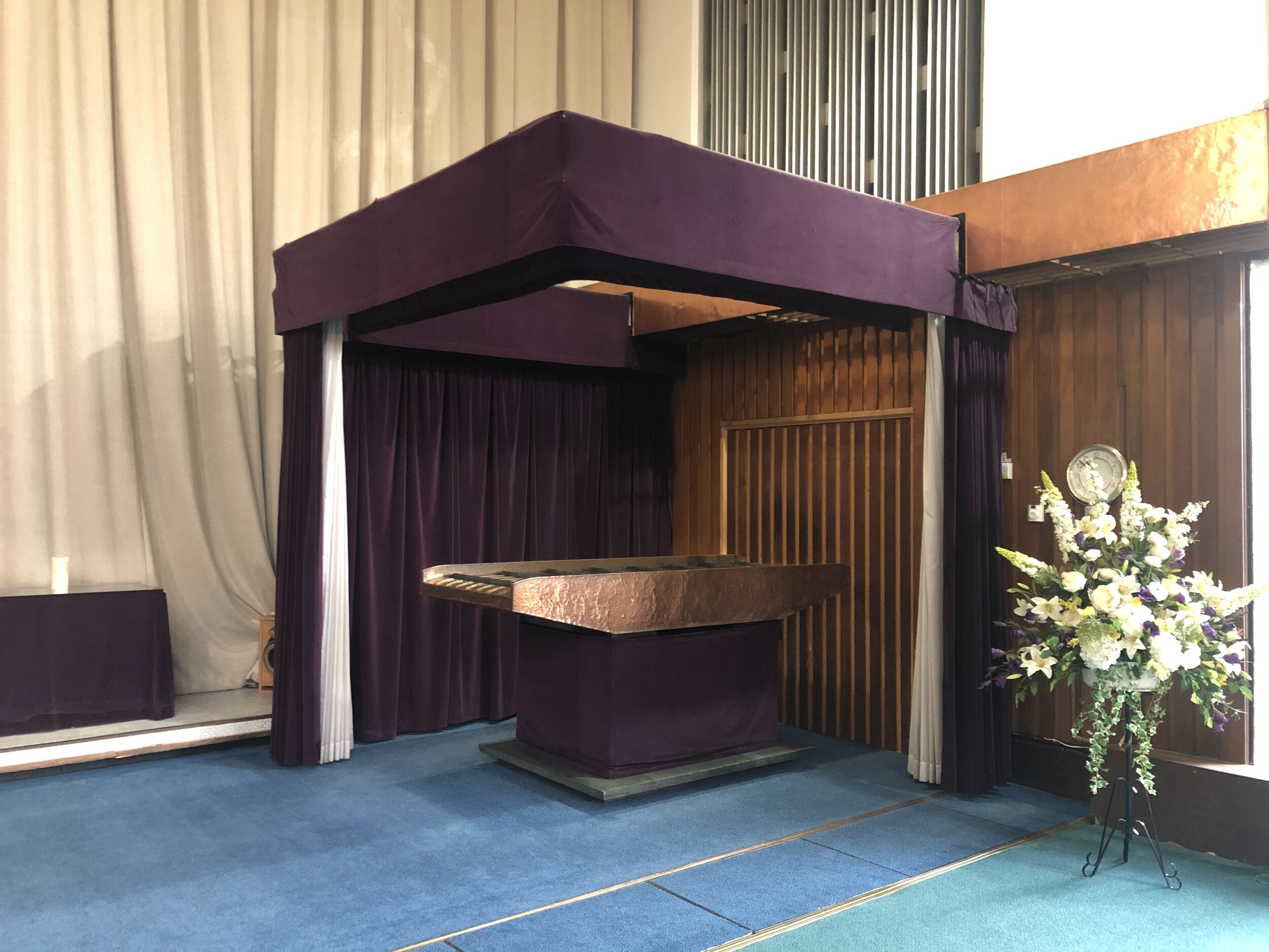 The catafalque and velvet curtains in the East Chapel of Croydon Crematorium
