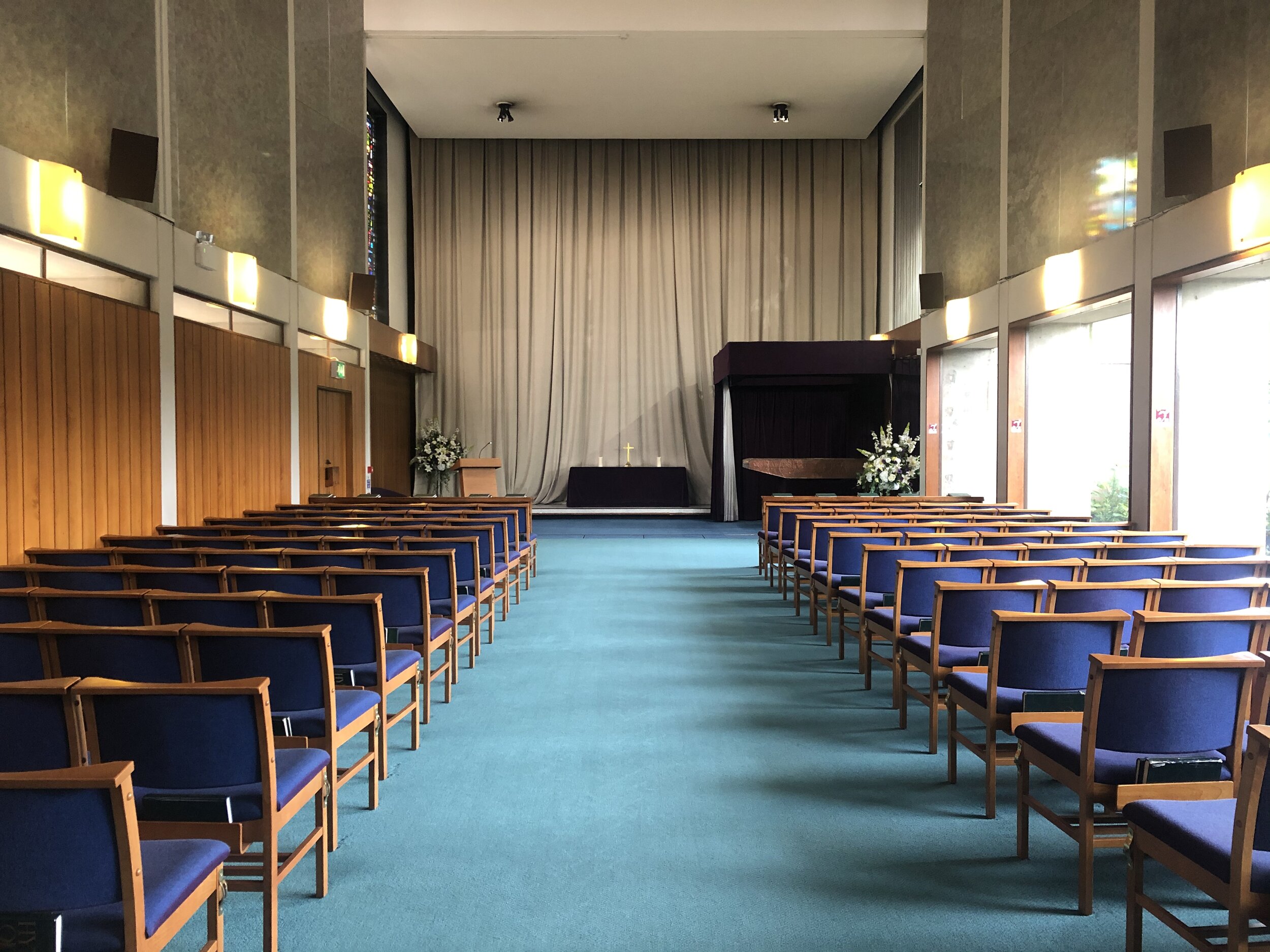 The East Chapel at Croydon Crematorium with upholstered seating and a spacious contemporary interior