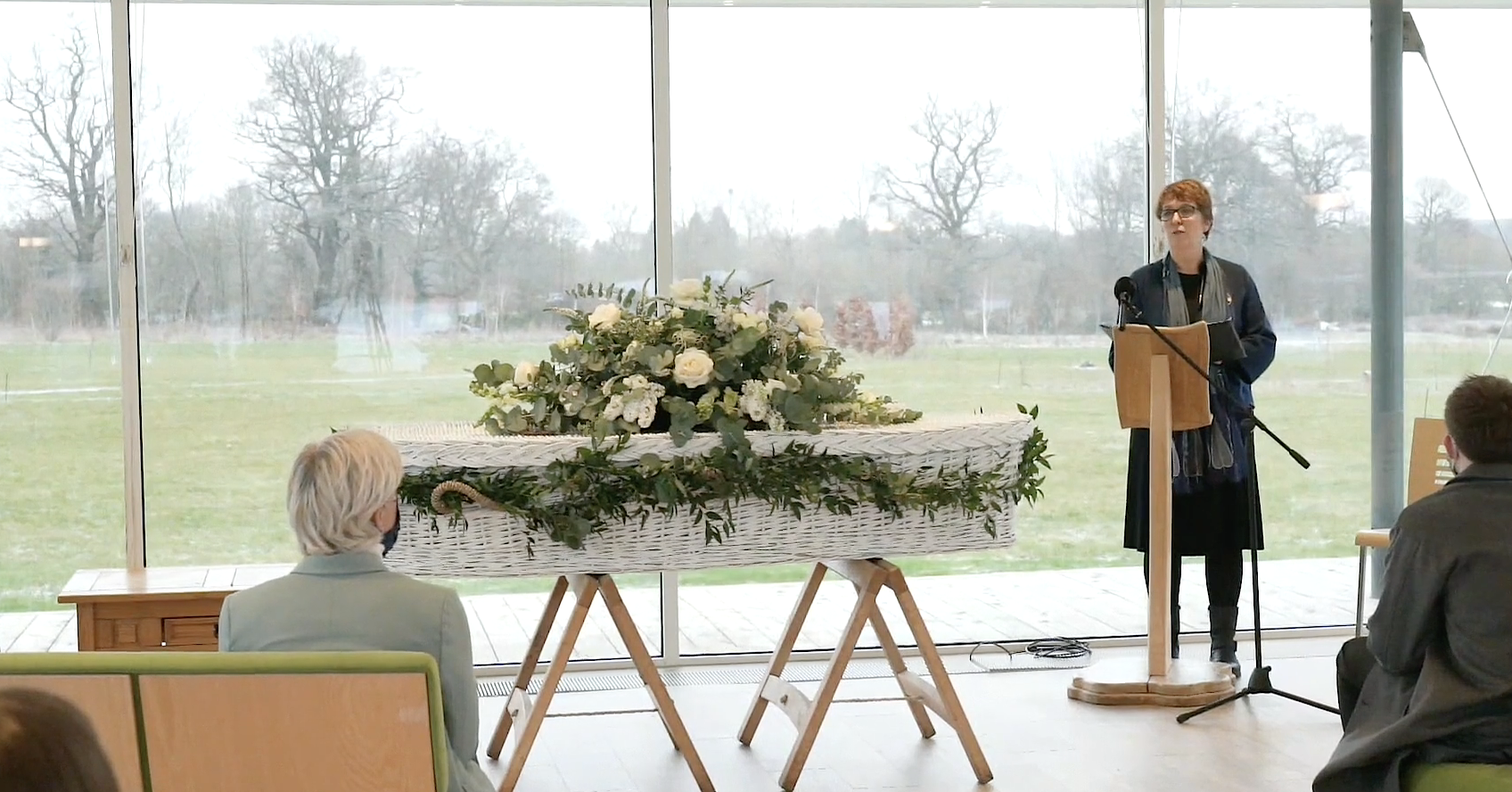 Michelle's funeral at Clandon Wood, with a white willow coffin and flowers in the ceremony room